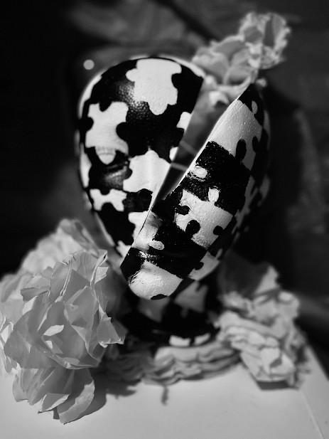 Sculpture of a face with puzzle pieces