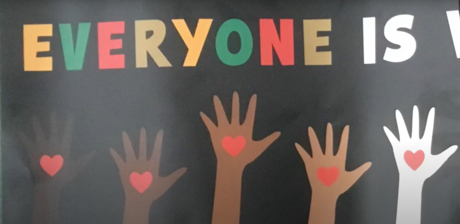 Paper cut outs of hands under the word "EVERYONE"