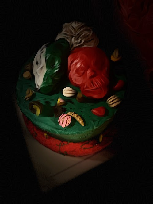 Image of a red and green skull with bread and other items