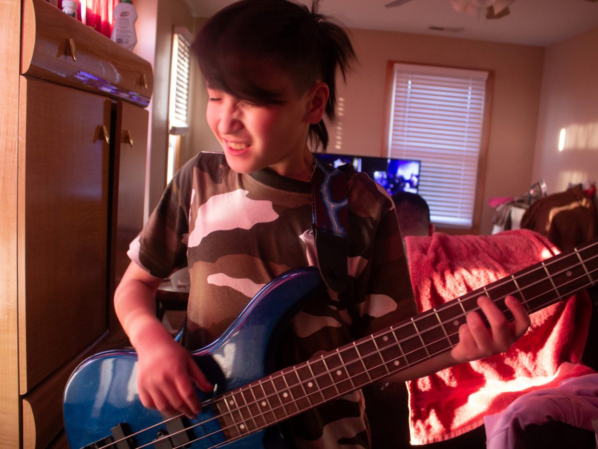 photo of a young boy playing guitar