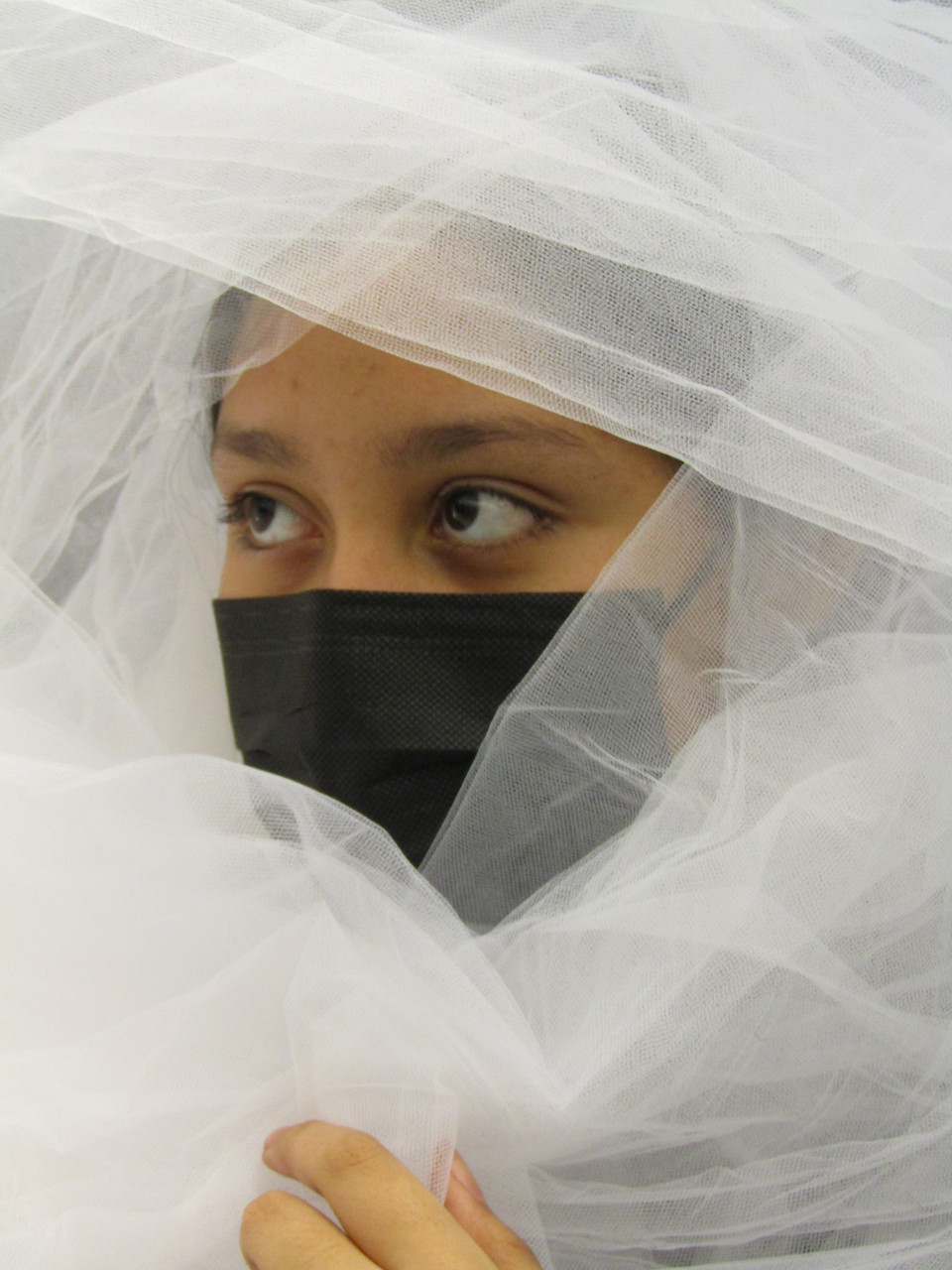 girl in black mask covered in veil