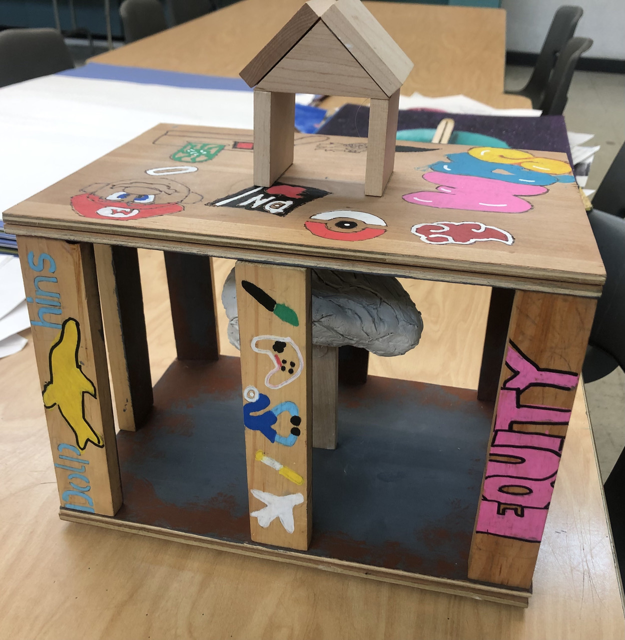 House made of wood with words and symbols painted on.