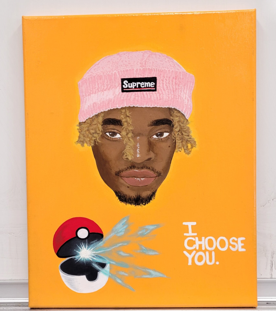 Painting of a guy with a pink hat and a pokeball