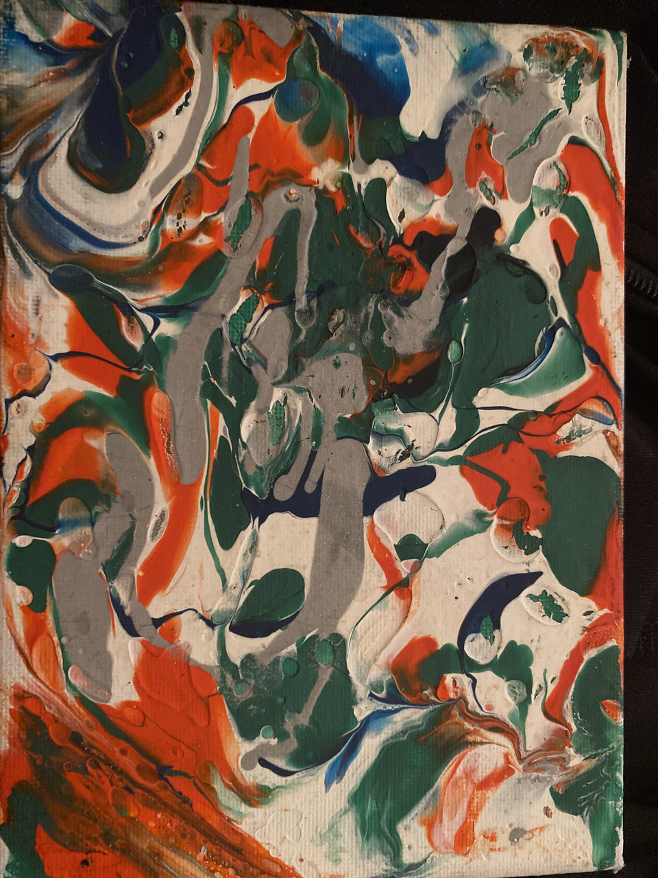 Gray, white, black, and orange paint by marble