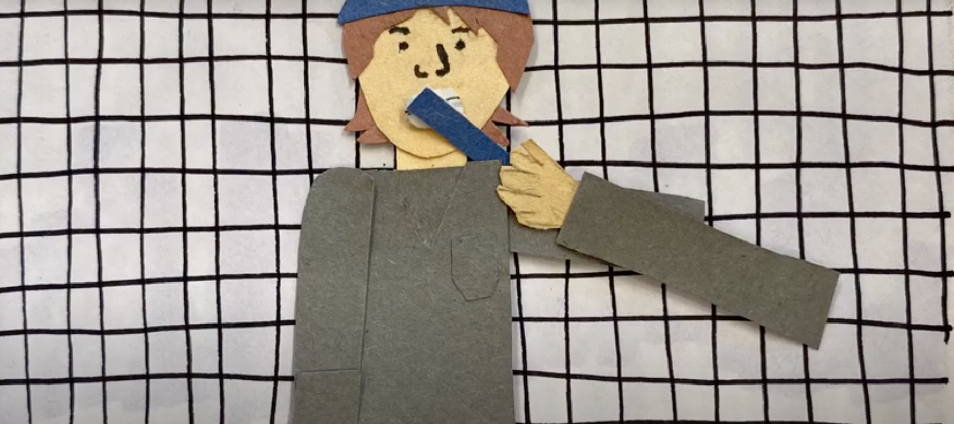 Paper cut out of a person standing in front of a grid