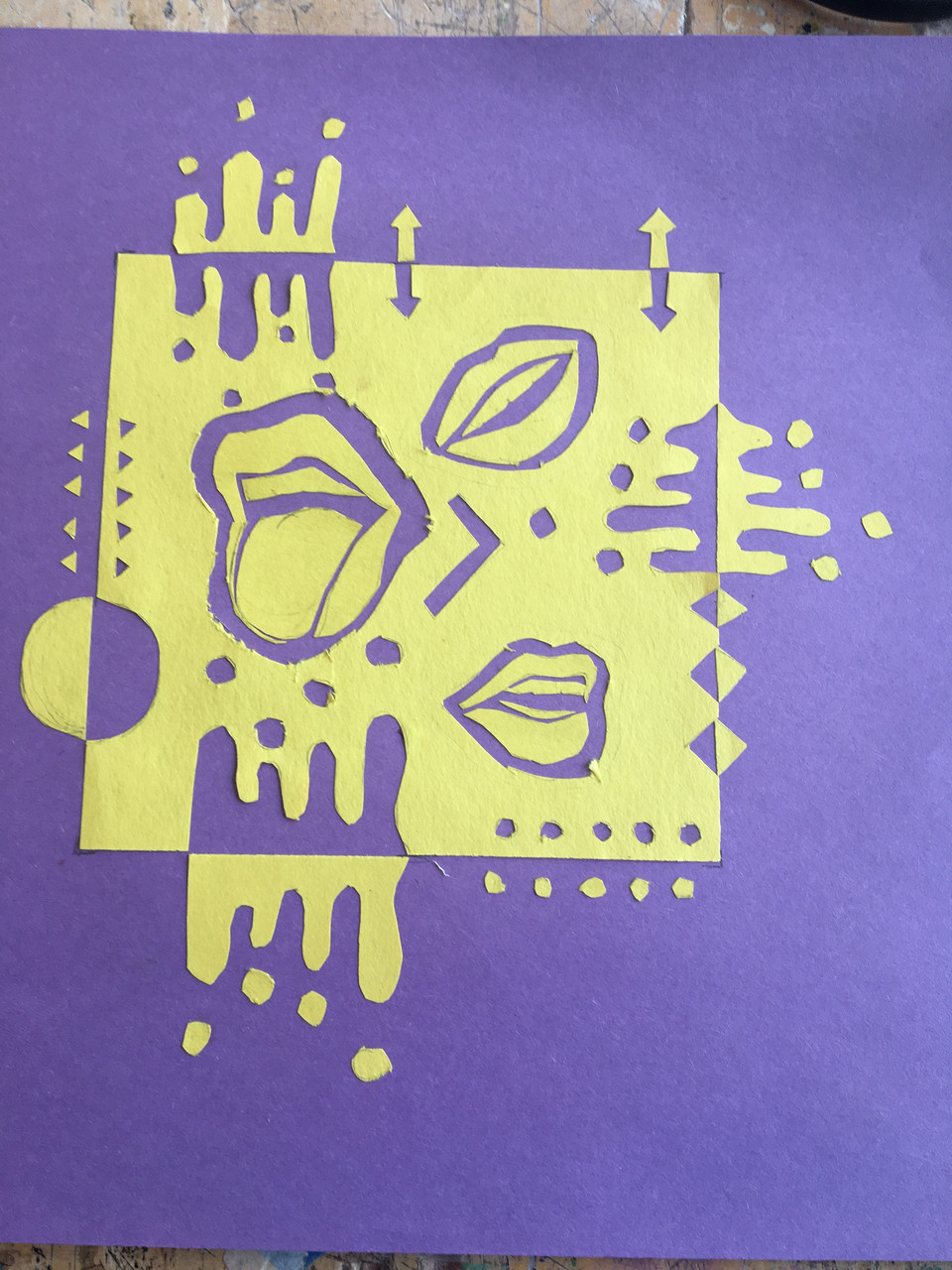Purple and yellow paper cut of lips