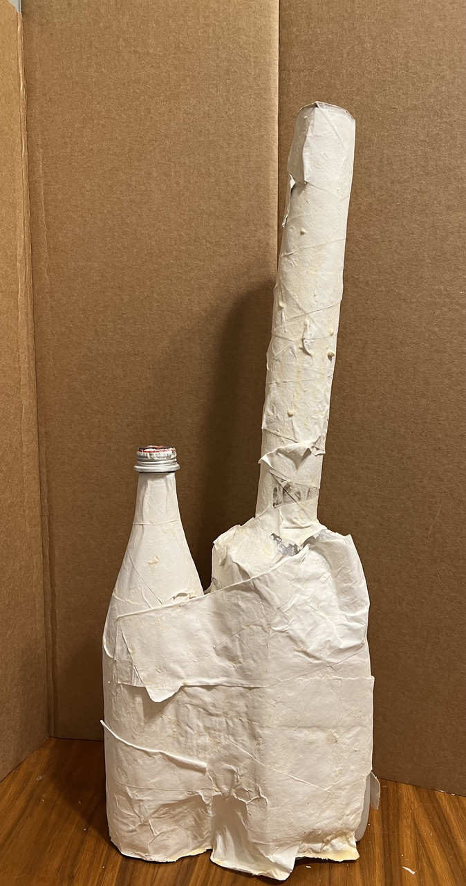 abstract sculpture of a bottle and taller object all in white