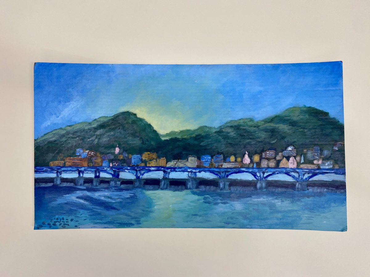Painting of a skyline with mountains, water, and a small city.