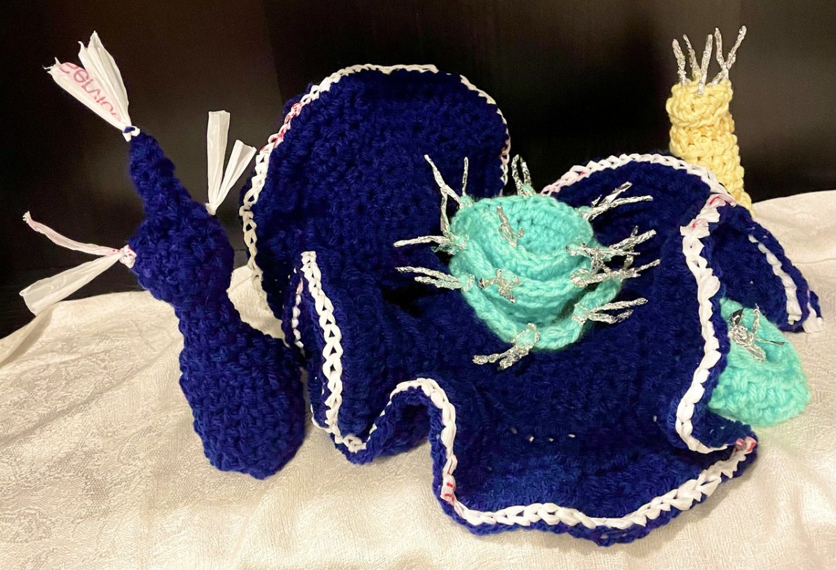 A blue yarn sculpture work with a ruffled texture.