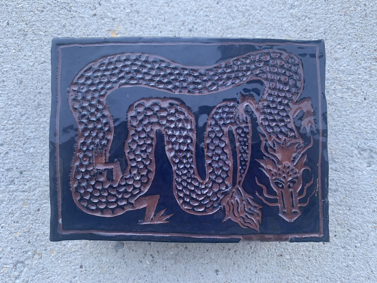 blue ceramic tile piece of a dragon