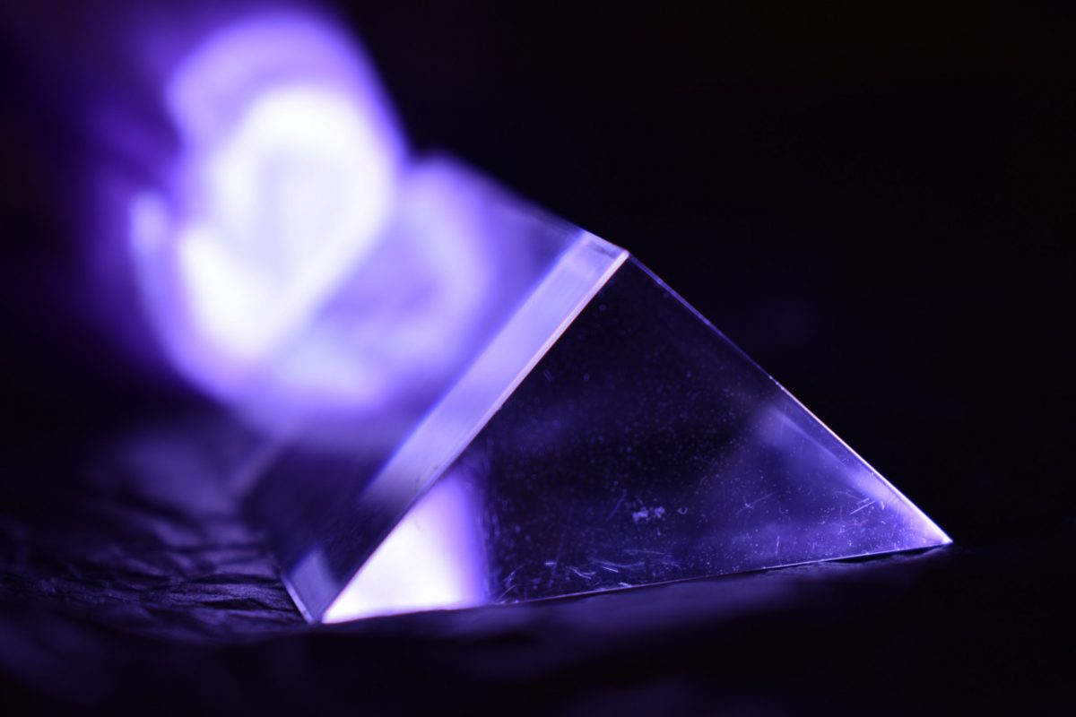 photo of a prism with a purple light