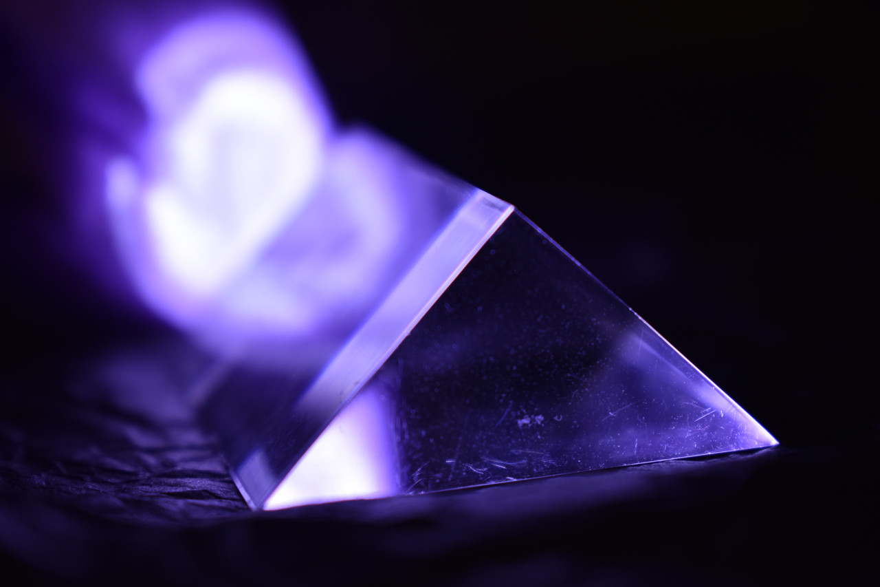 photo of a prism with a purple light