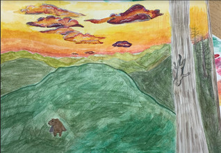 Landscape of orange sky with green mountains and a tree.