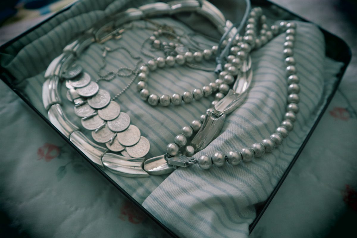 Various pieces of silver metal on a striped sheet