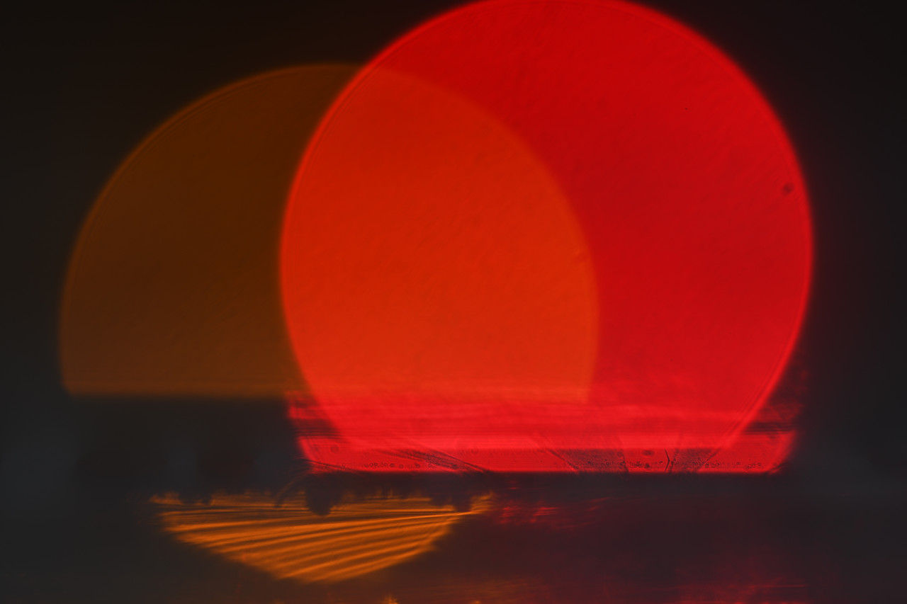 Two red circle with black background.