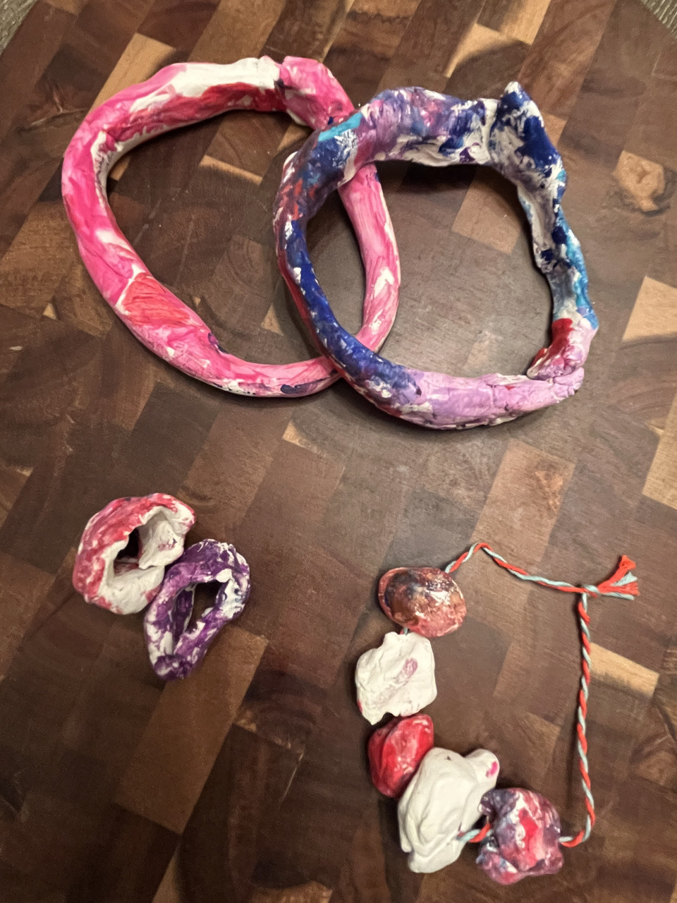 Clay jewelry painted purple or paint.