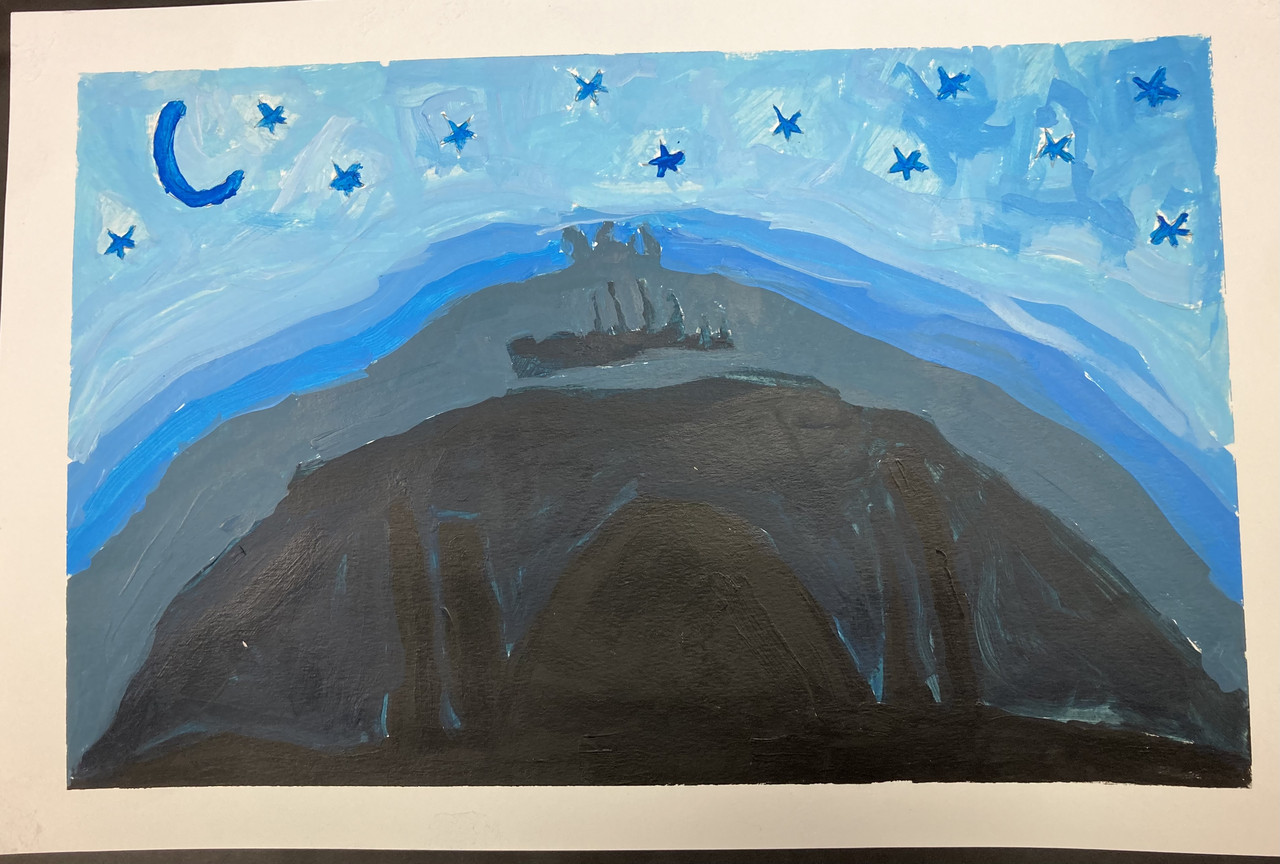 black building silhouetted against a blue night sky