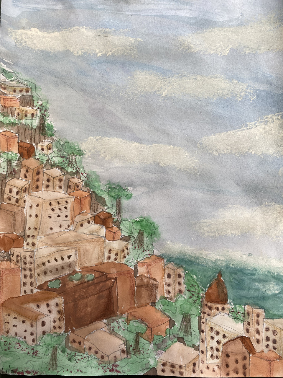 Brown buildings on a hillside overlooking water