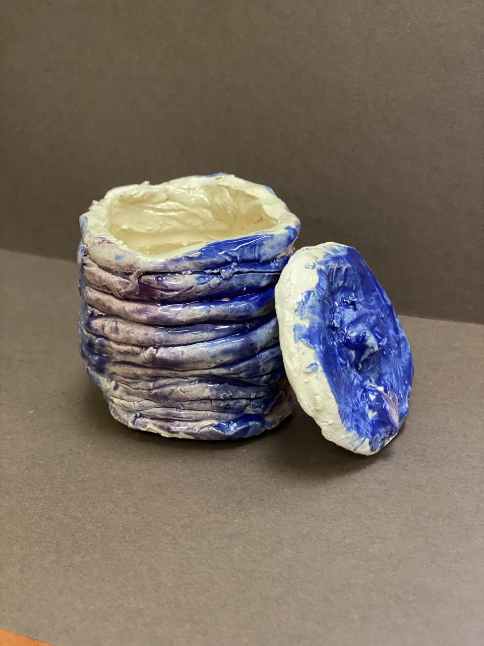 Ceramic piece with blue and purple color.