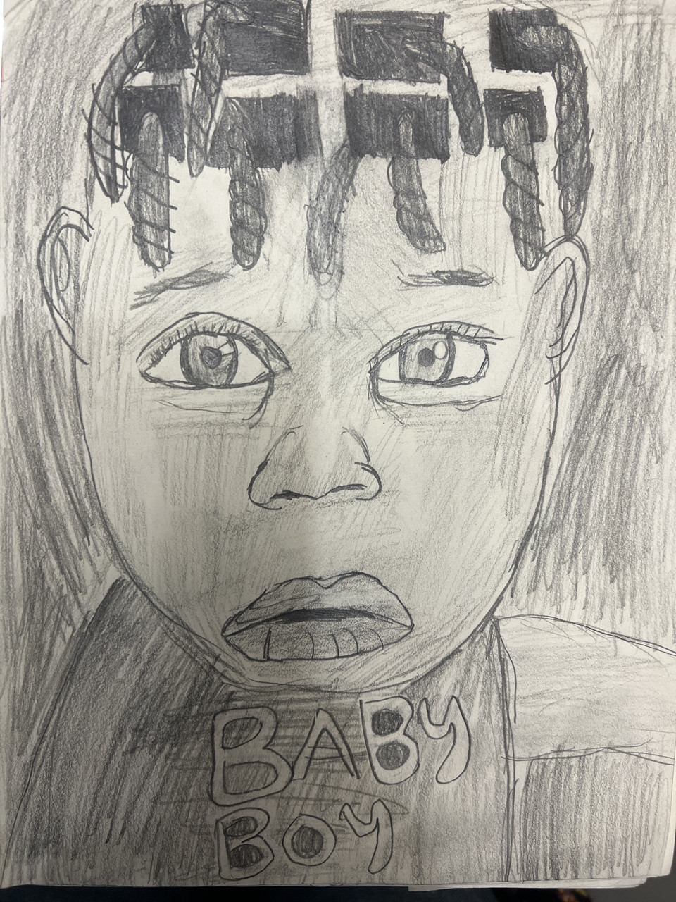 Drawing of a child with a shirt on that says "Baby."