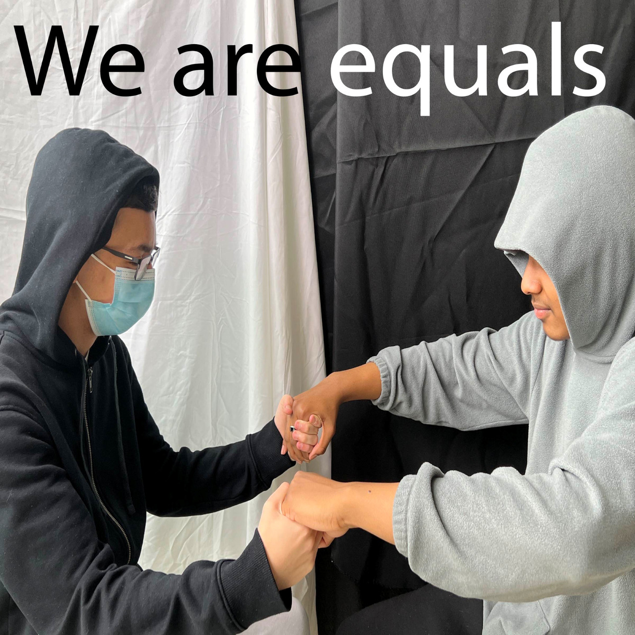 Photograph of duotones with the text: "We are equals."
