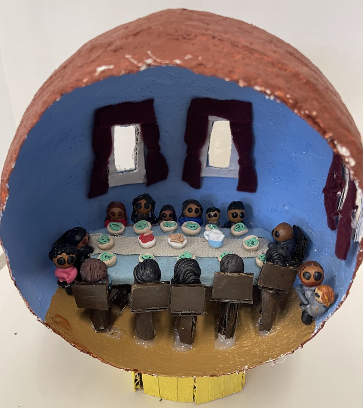 Sculpture of a sphere with a family table.