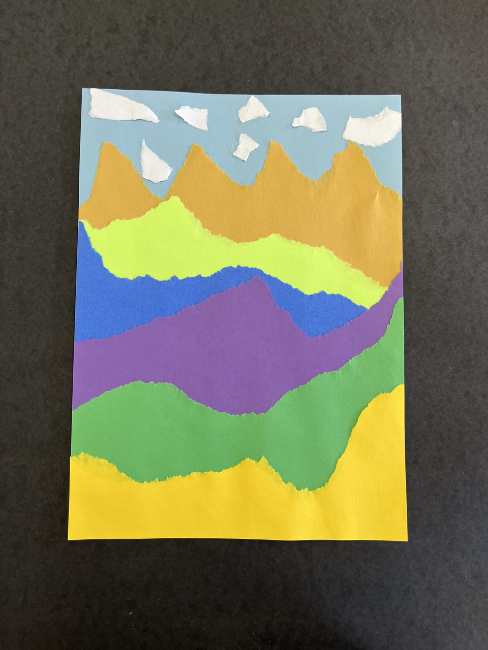 Colorful landscape created with torn paper.