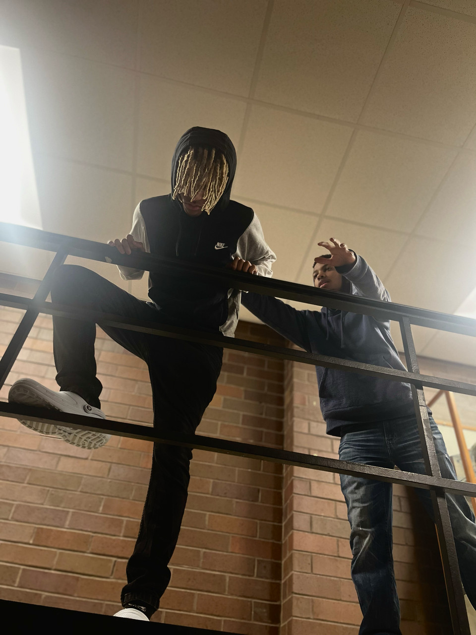 Photo of someone about to jump and another person stopping them.