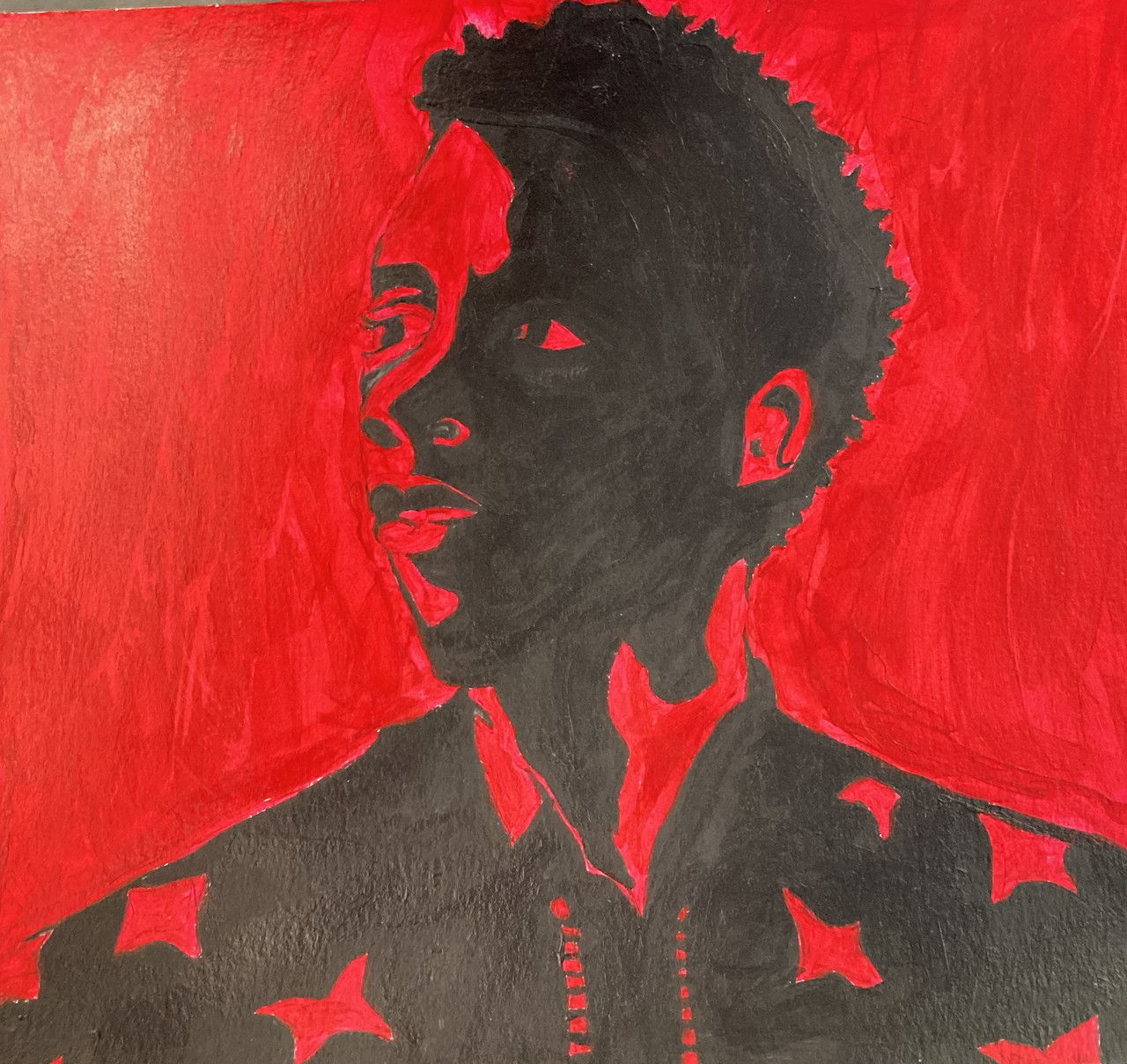 portrait of chadwick Boseman in black, on a red background
