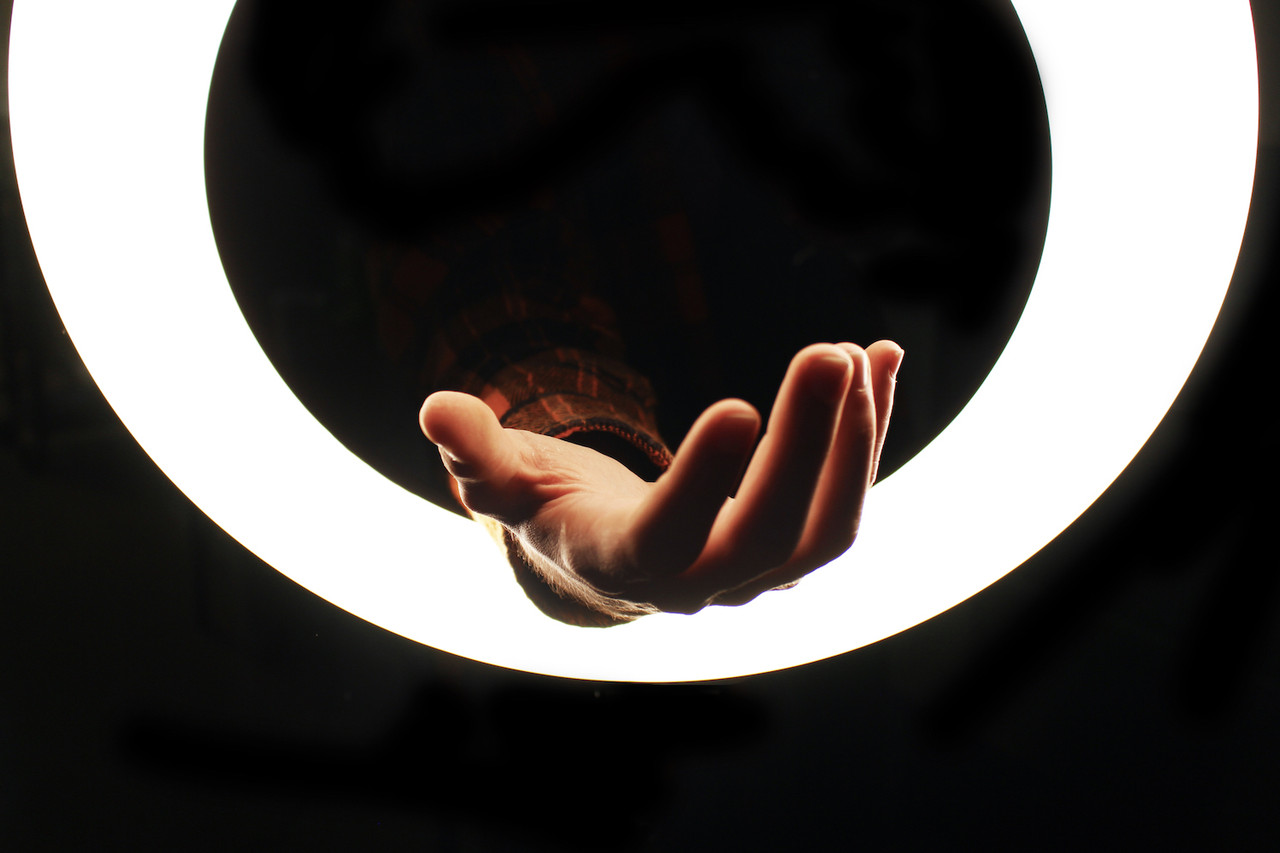 Hand in a ring light.
