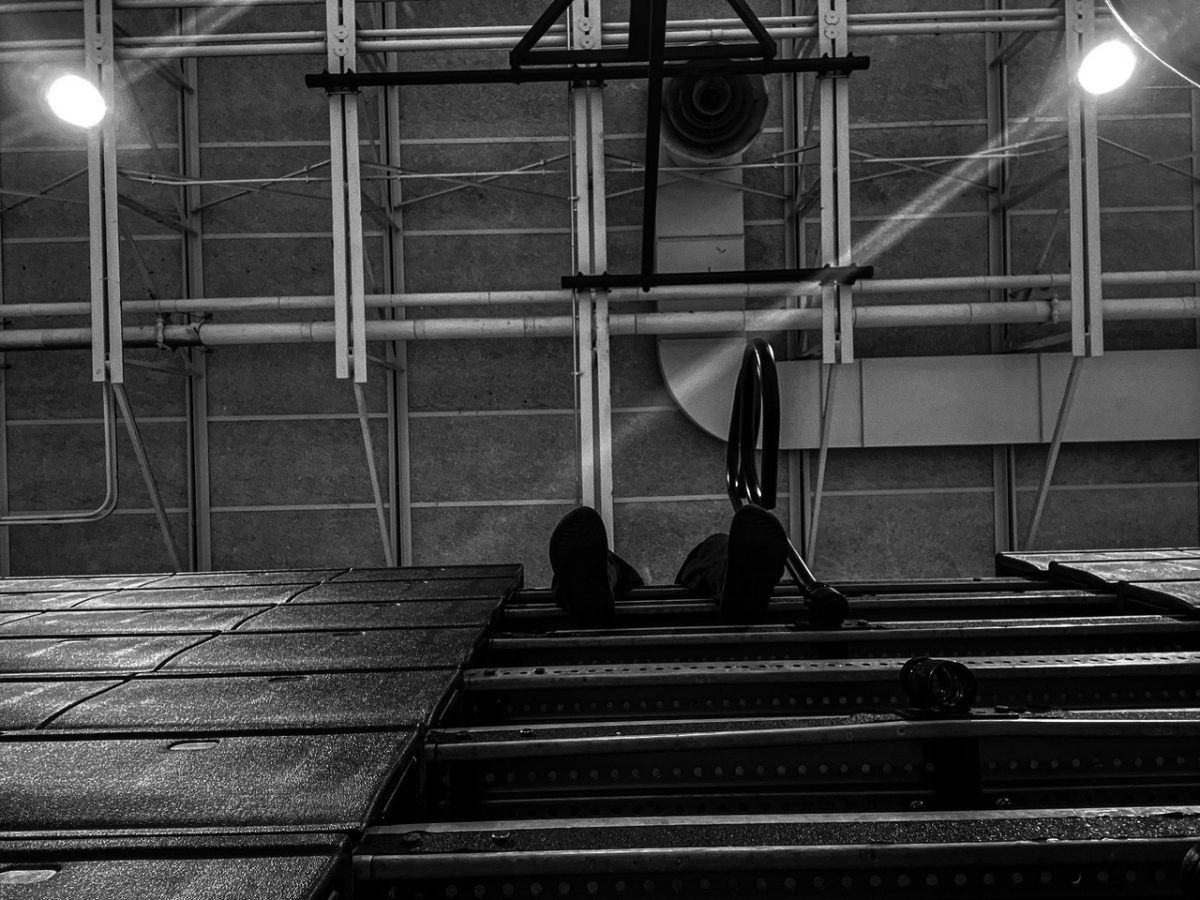 Photo of a basketball hoop and bleachers.