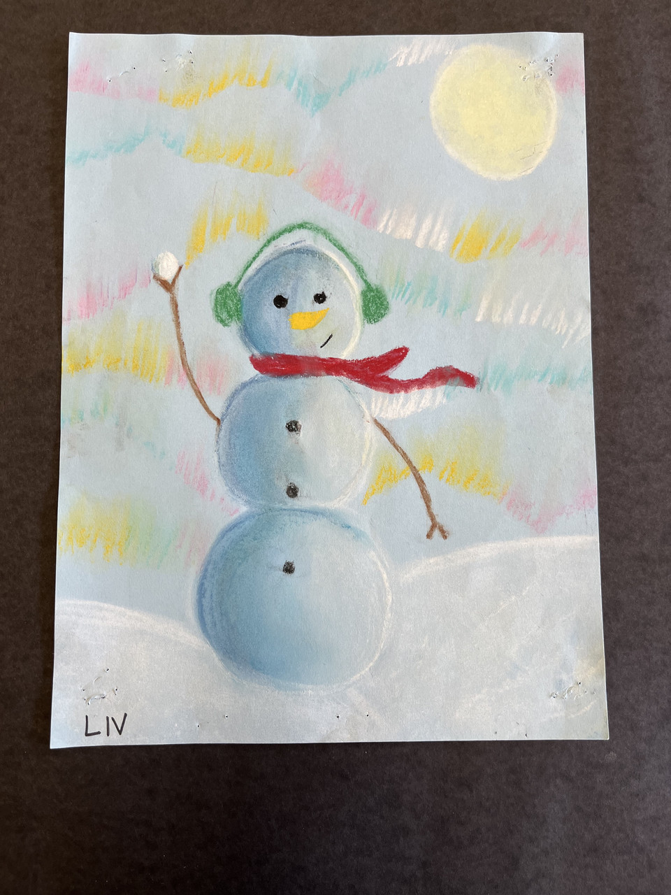 Snowman with northern lights drawn with chalk pastel.
