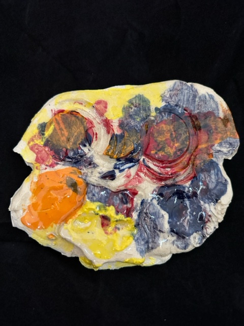 Colorful ceramic sculpture of a face.
