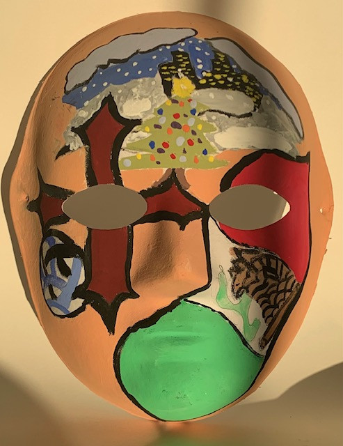 Paper mache mask painted with different imagery and symbols.