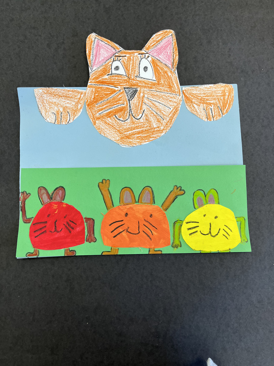 Cats drawn with crayon and tempera paint.