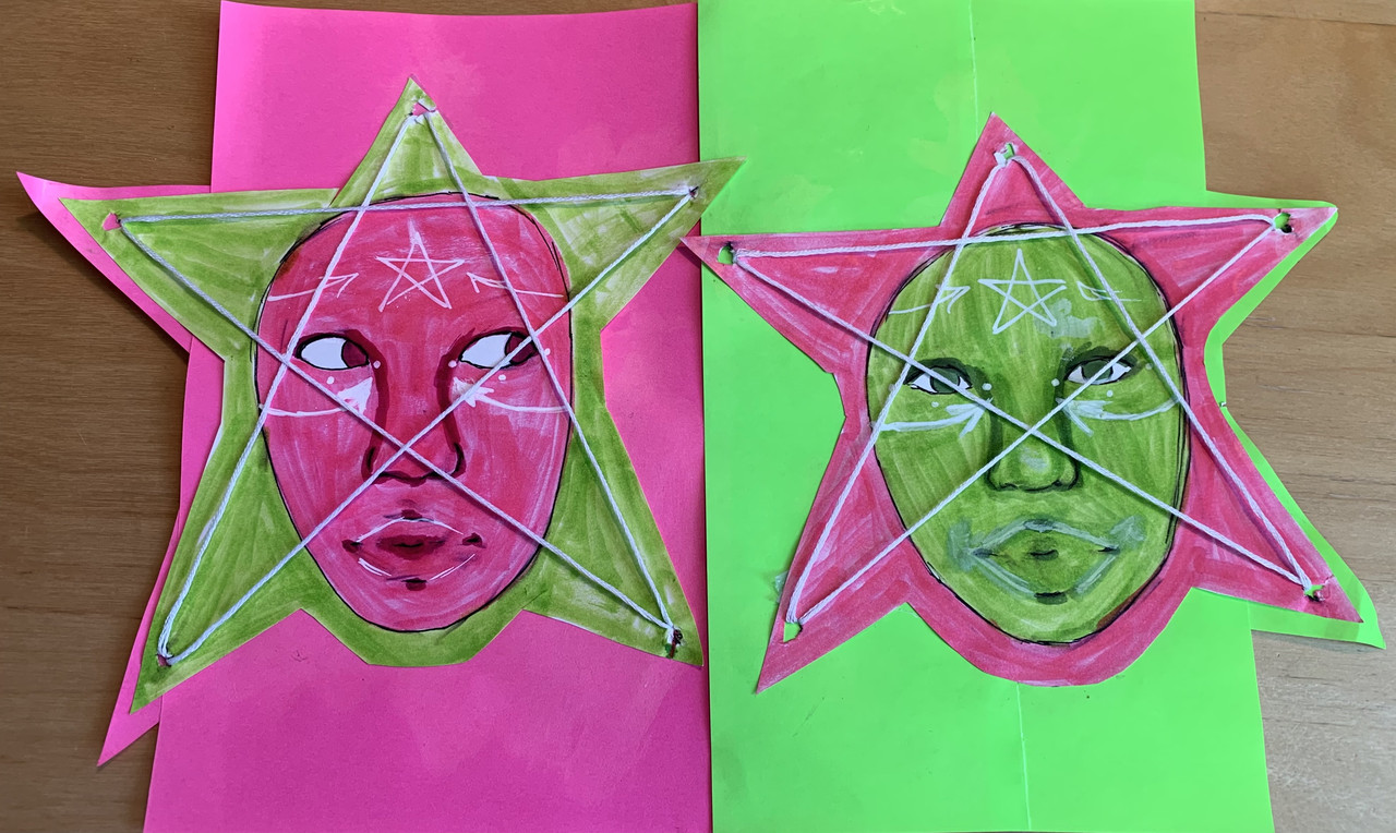 pink face and green face in stars with white string making the star on top