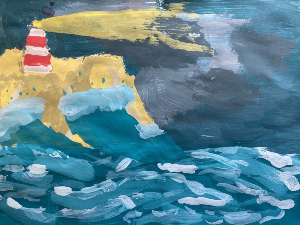 Red and white lighthouse looking over blue ocean