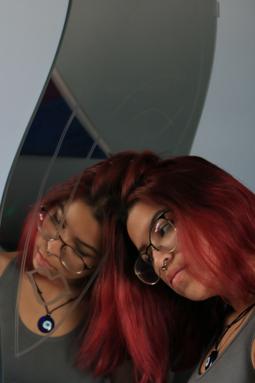 Person leaning against a mirror.