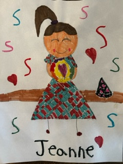 Person with dark hair, a high ponytail and a blue and red dress holding a heart.
