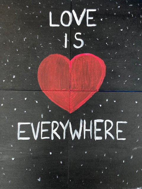 Text "Love is Everywhere" with a heart in space.