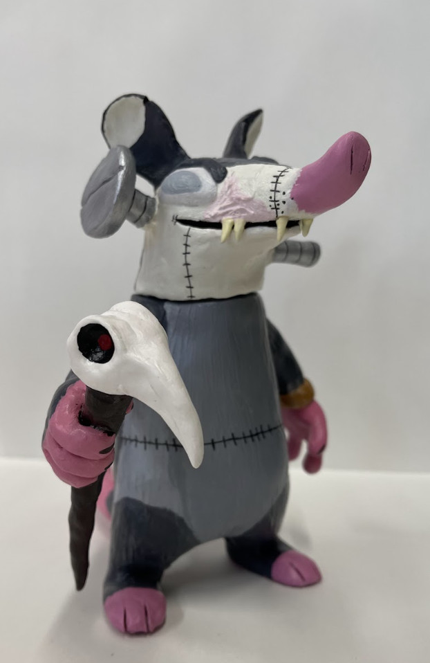 Sculpture of an opossum character.