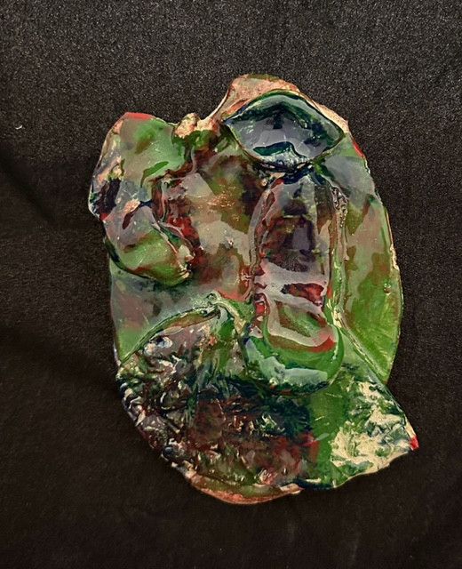 Ceramic face painted with various colors.