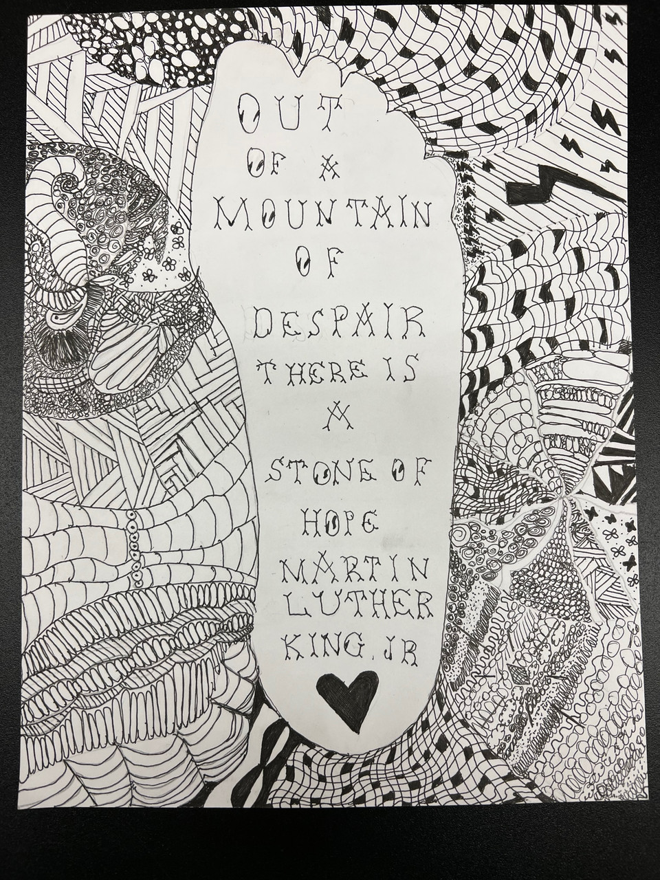 Foot with quote "out of a mountain of dispair there is a stone of hope" Martin Luther King Jr. B/w abstract illustrations around foot.