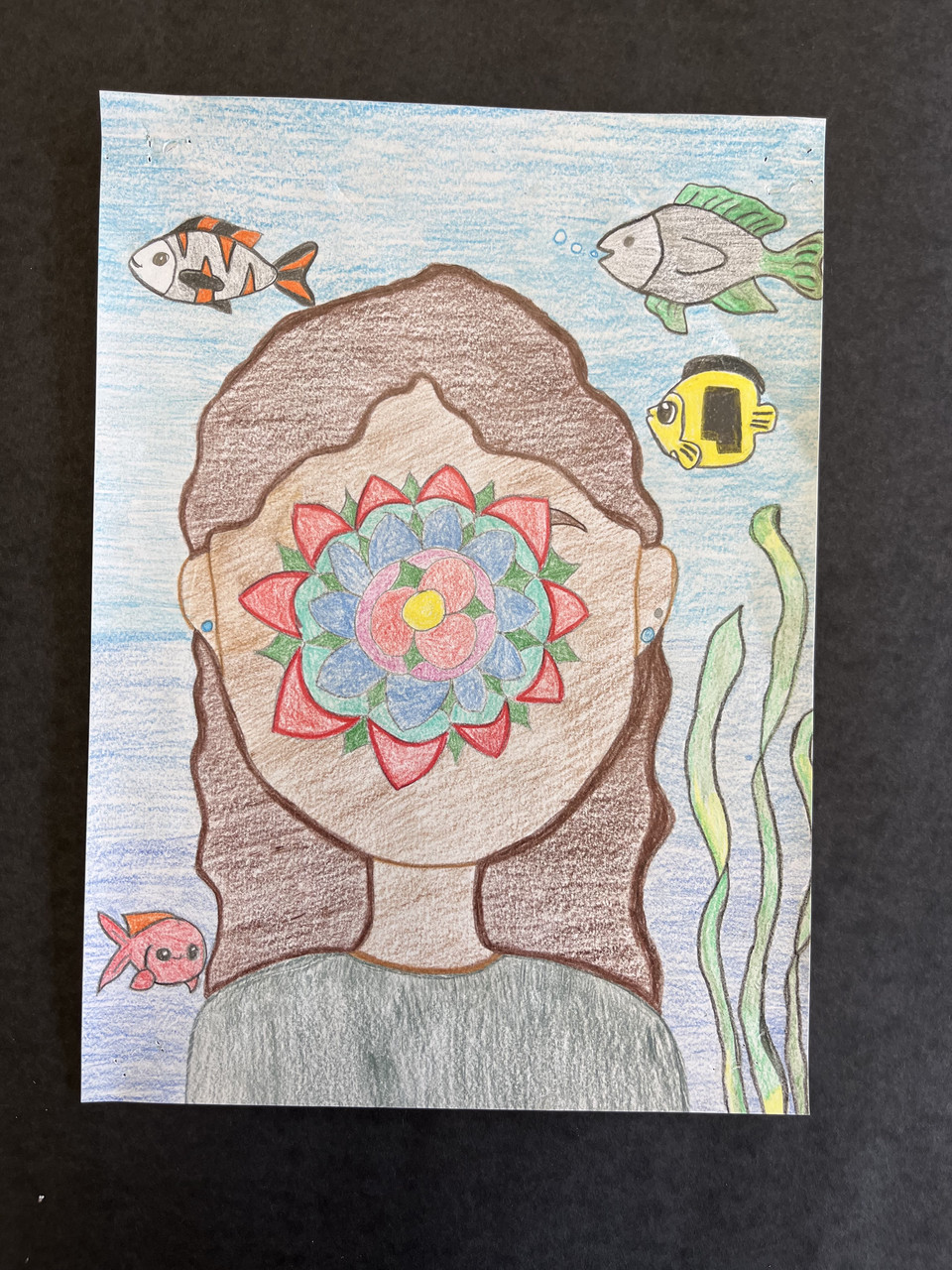 Self portrait of Ellie Glenn done in Magritte's style with fish in the background.