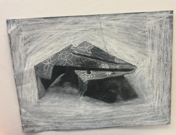 Black and white drawing of folded paper.