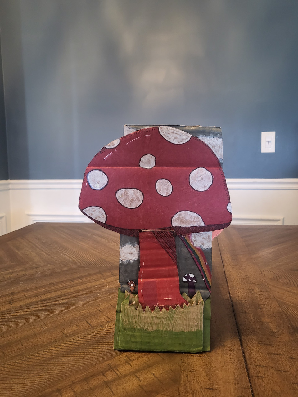 Sculpture of a red mushroom with white spots.