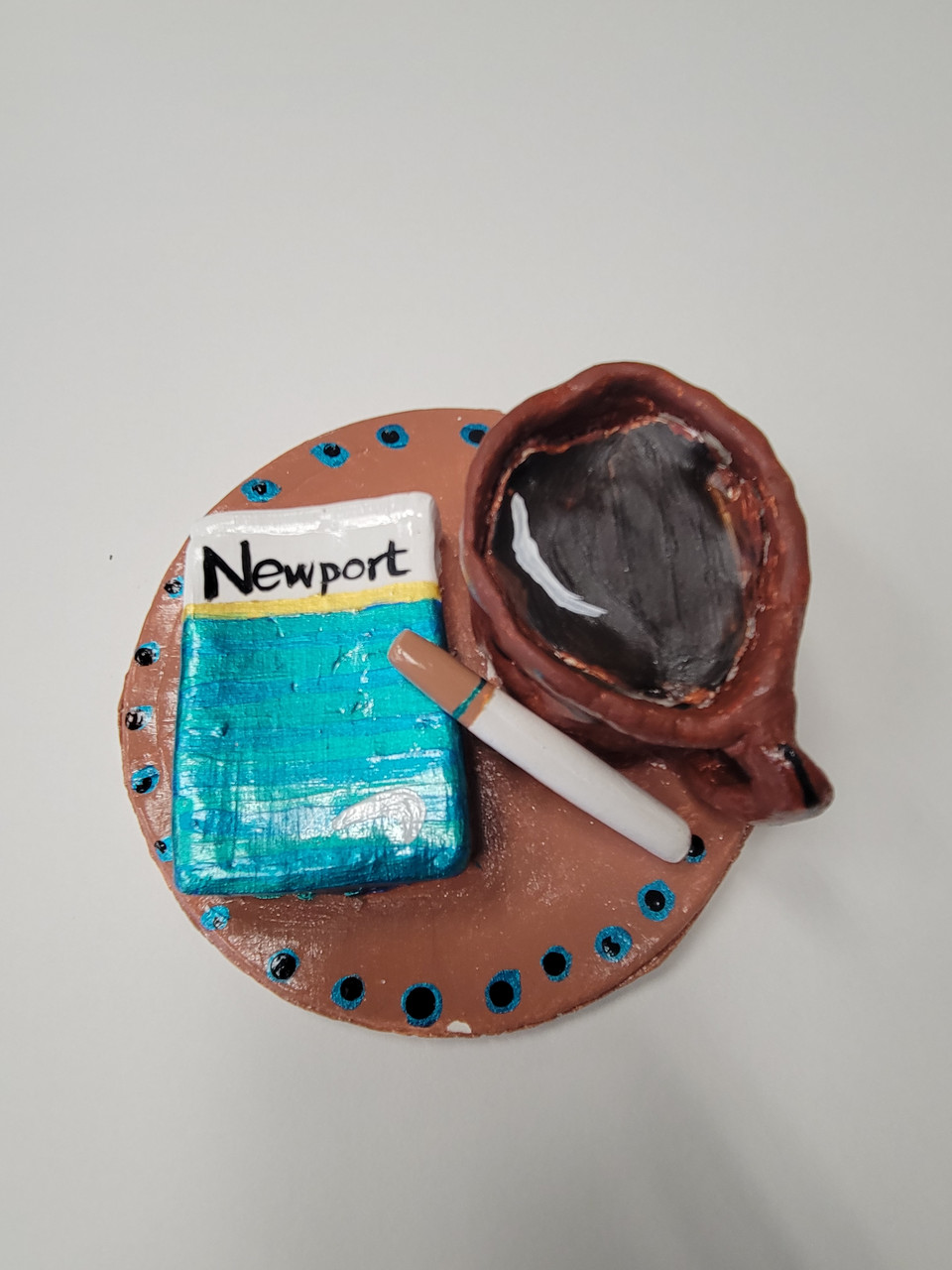 sculpture of cigarette box and coffee.