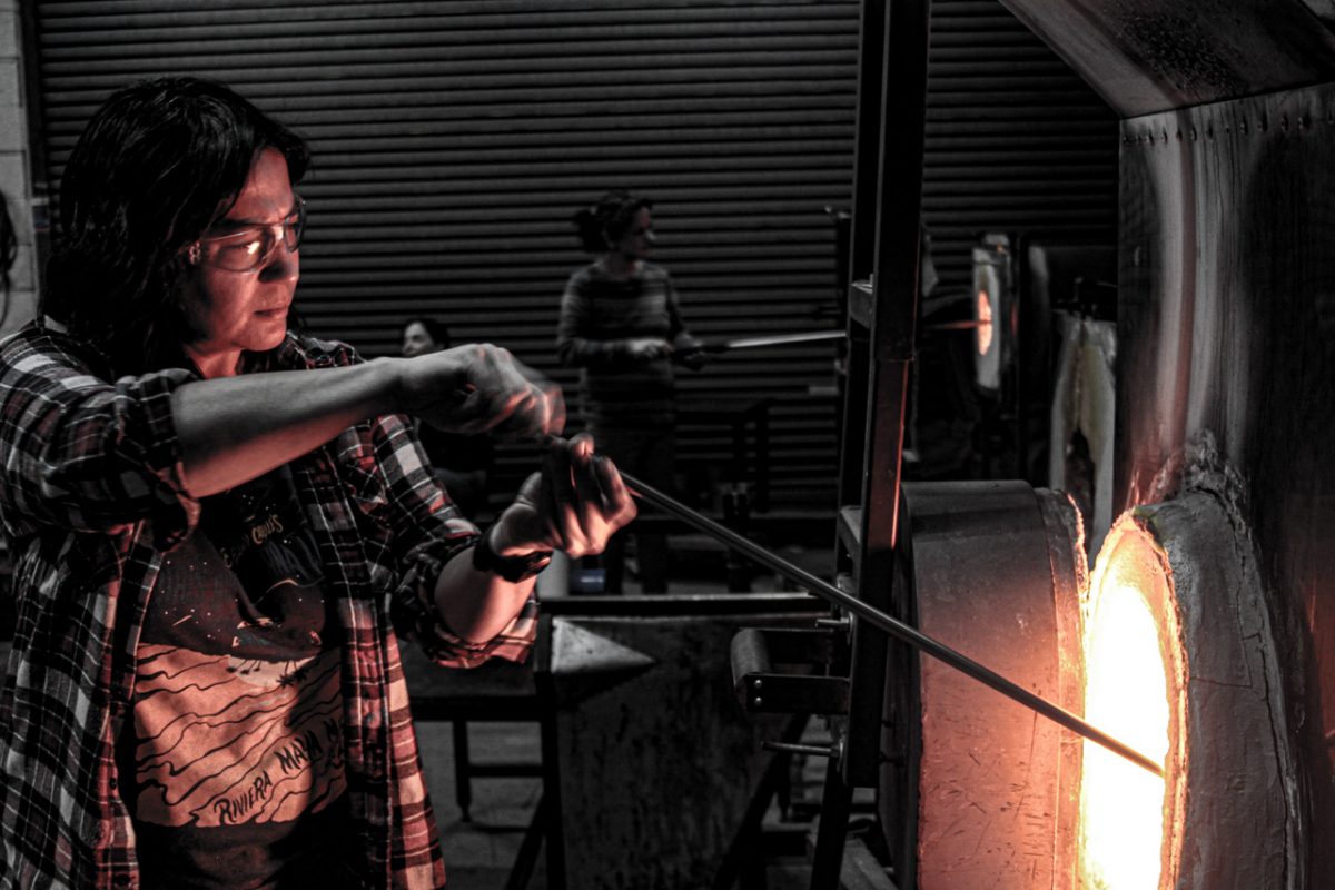 Photo of someone glassblowing.