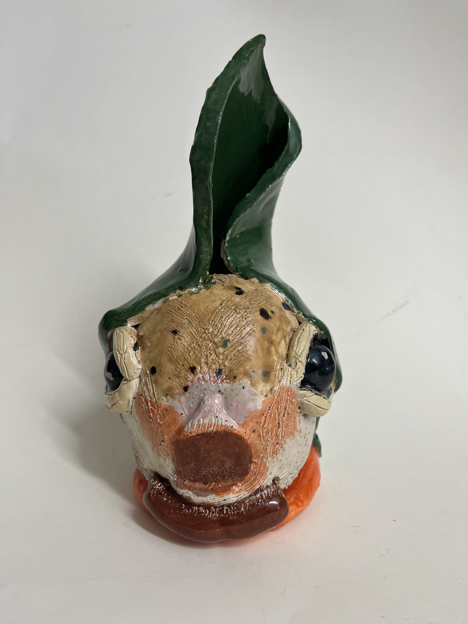 Clay sculpture of a squirrel.