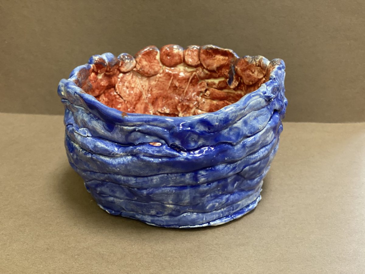 Bowl with painted blue outside and red inside.